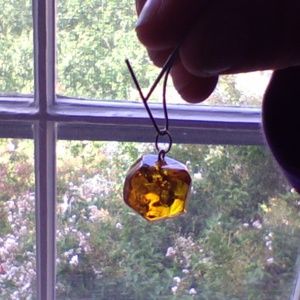 Amber pendant; round faceted 3D. Catches light!